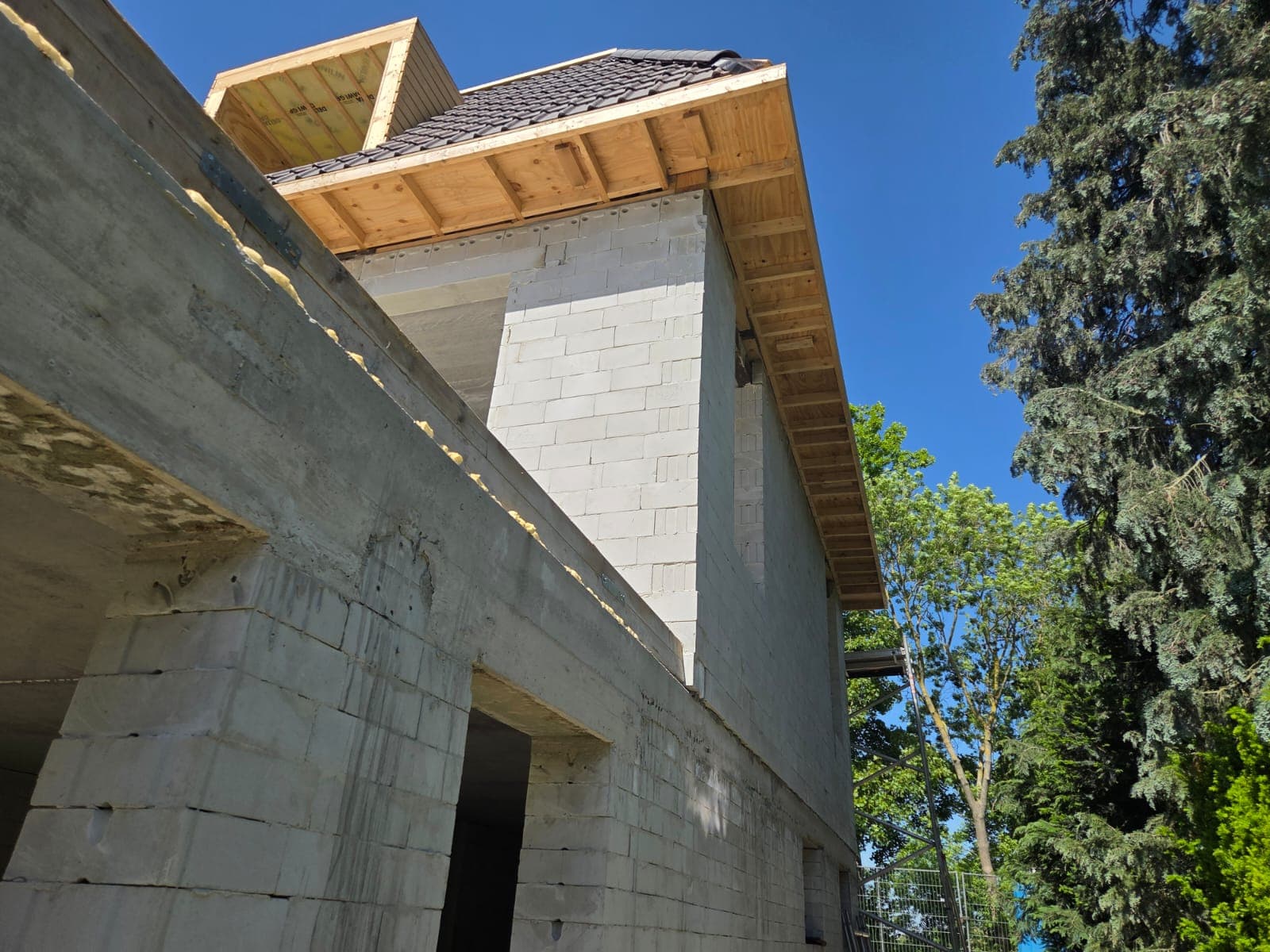 Construction worker installing wooden beams